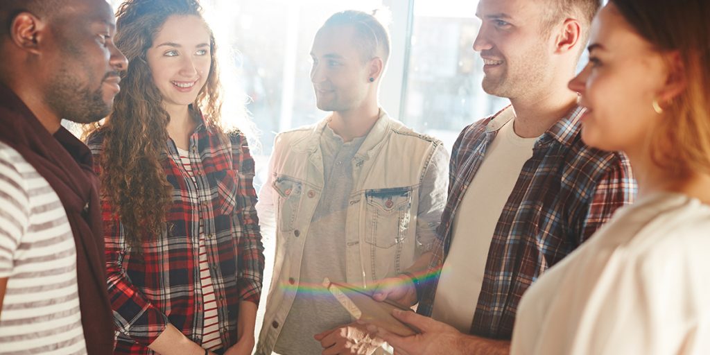 group of younger men and women gather in a support group circle Colorado TMS